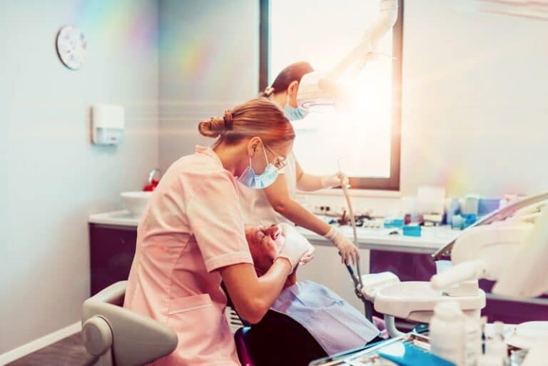 two nurses with an implant patient, How Do Dental Implants Help Me?