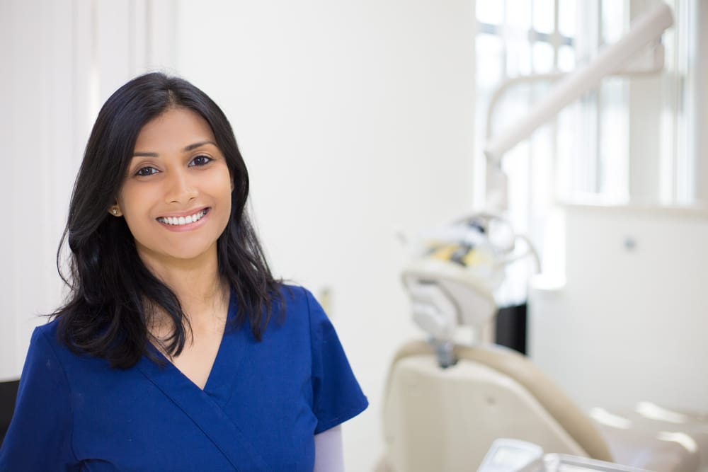 A smiling female dentist in her office