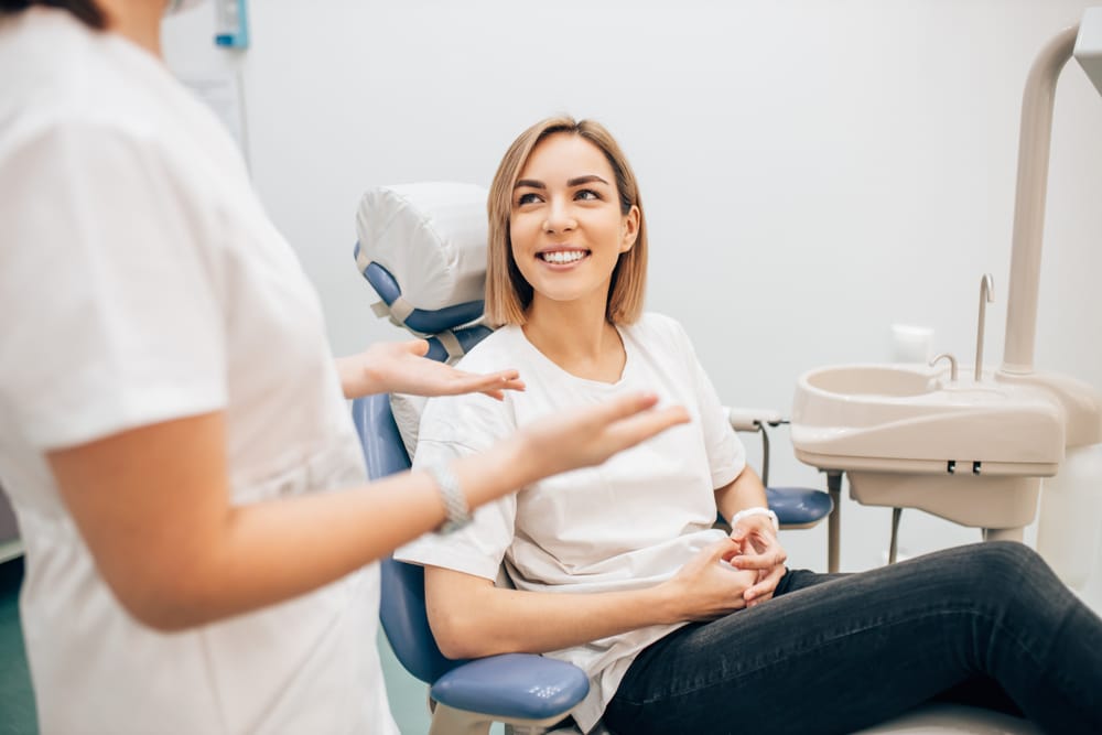 A happy female patient in a dentist’s office