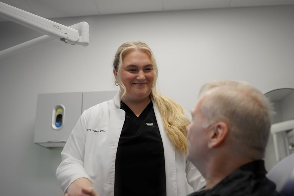 A happy female patient in a dental office