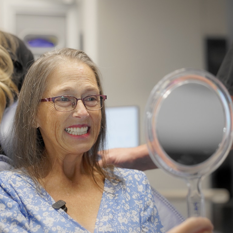 female dentist examining a male patient in a modern dental clinic.