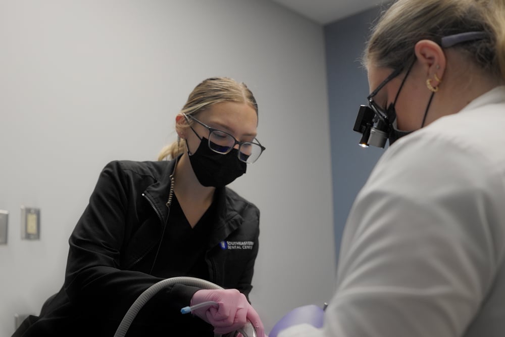 A dentist puts inhalation sedative mask on their patient